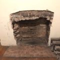 Fireplace brick arch in need of repair.